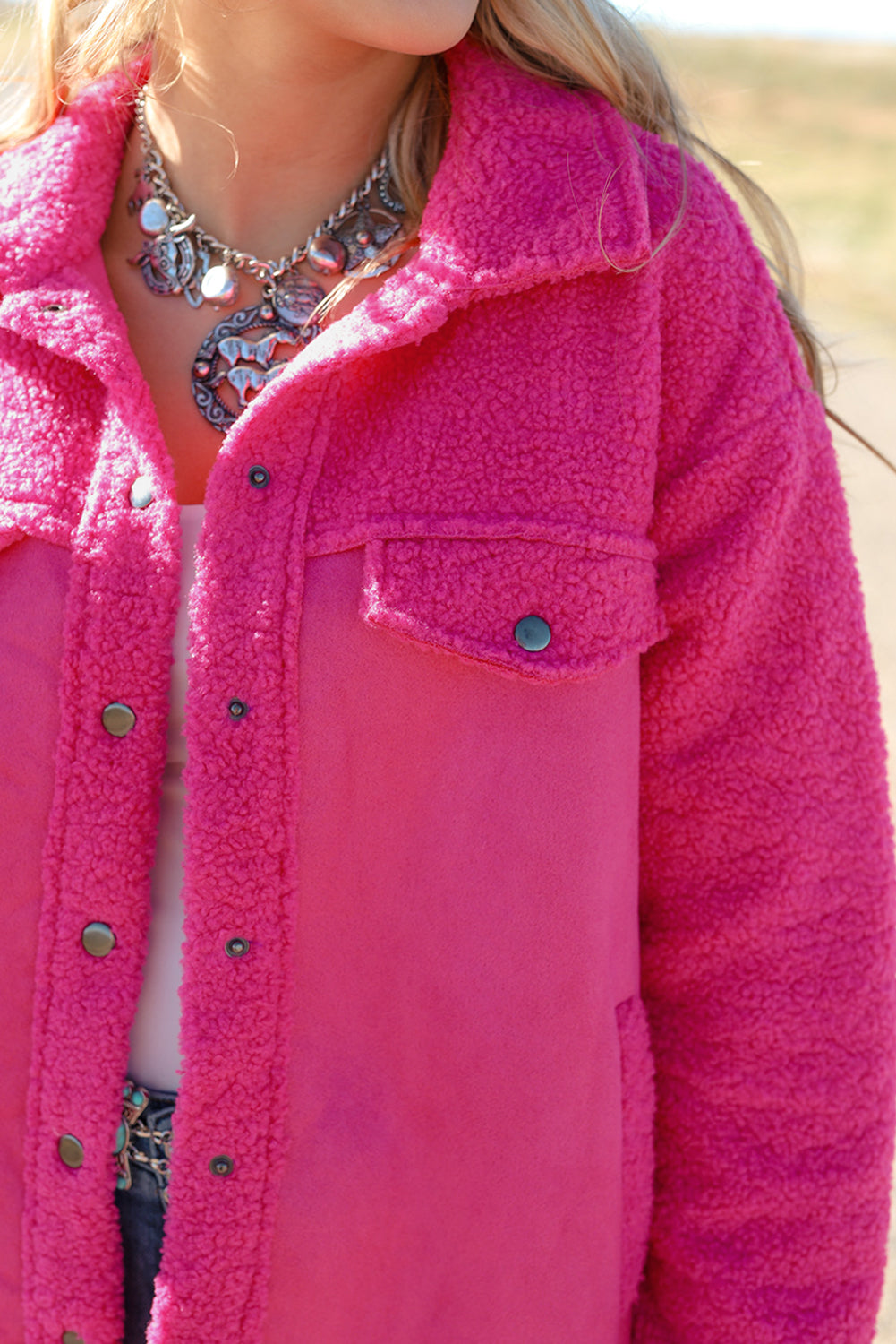 Introducing a cozy yet vibrant addition to your wardrobe: the Bright Pink Faux Suede Sherpa Button-Up Cardigan. Crafted with comfort and style in mind, this cardigan offers both warmth and flair, perfect for the modern woman who values both fashion and functionality