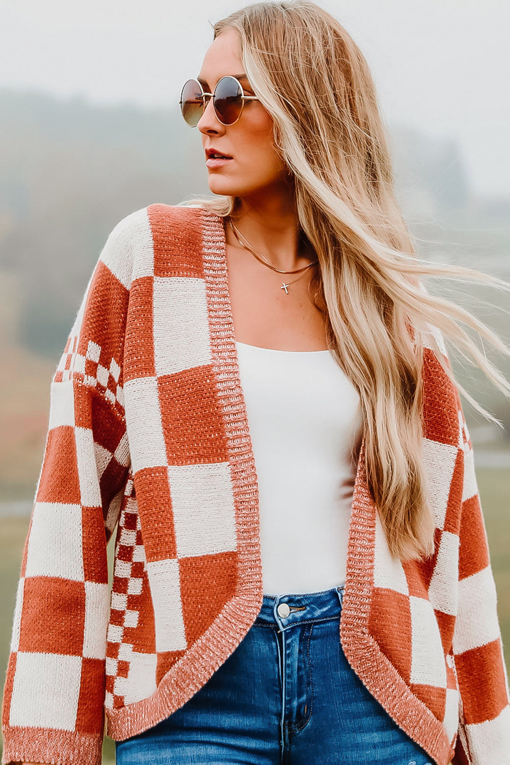 Introducing our Chestnut Mix Checkered Cardigan, a chic and classic addition to any wardrobe. Its checkered pattern is sure to make you fall in love with this knit coat. The open front design makes it easy to layer over any outfit, perfect for pairing with jeans, skirts, or dresses.