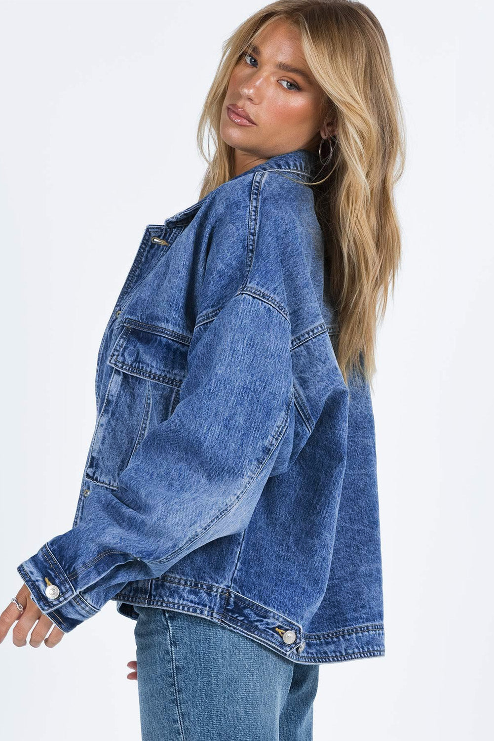 Get ready to drop it like it's hot in our Blue Chest Pockets Drop Shoulder Loose Denim Jacket! With its trendy oversized fit, convenient chest pockets, and unique dropped shoulder design, this jacket is perfect for a casual, yet stylish look. Say hello to your new favorite wardrobe staple, available now in blue denim.