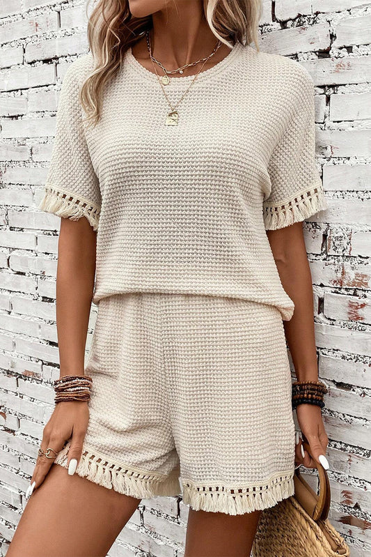 Elevate your style with our Beige Fringe Trim Textured Short Two Piece Set. This chic set features delicate fringe trim and a textured fabric, adding dimension and movement to your look. Perfect for any occasion, this set will make you feel effortlessly stylish and confident!