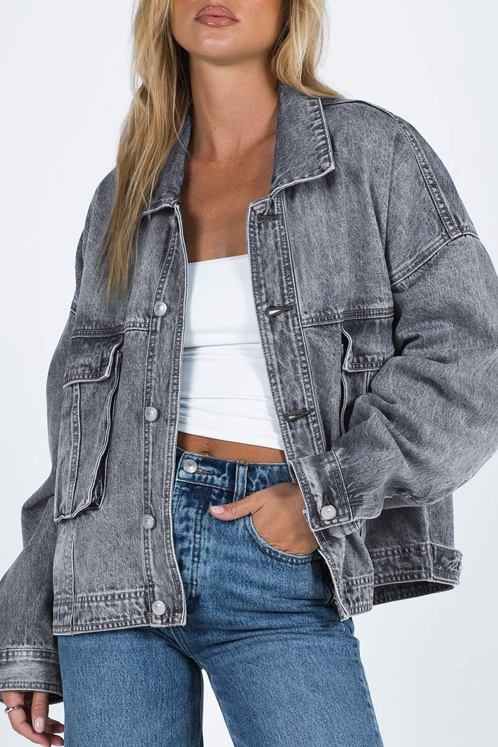 Get ready to rock any look with our Gray Chest Pockets Drop Shoulder Loose Denim Jacket. The ultimate layering piece, its versatile fit is perfect for all body types. The metal buttons add a touch of cool and durability, while the drop shoulder design gives off an effortless vibe. Plus, the chest pockets add both practicality and style.