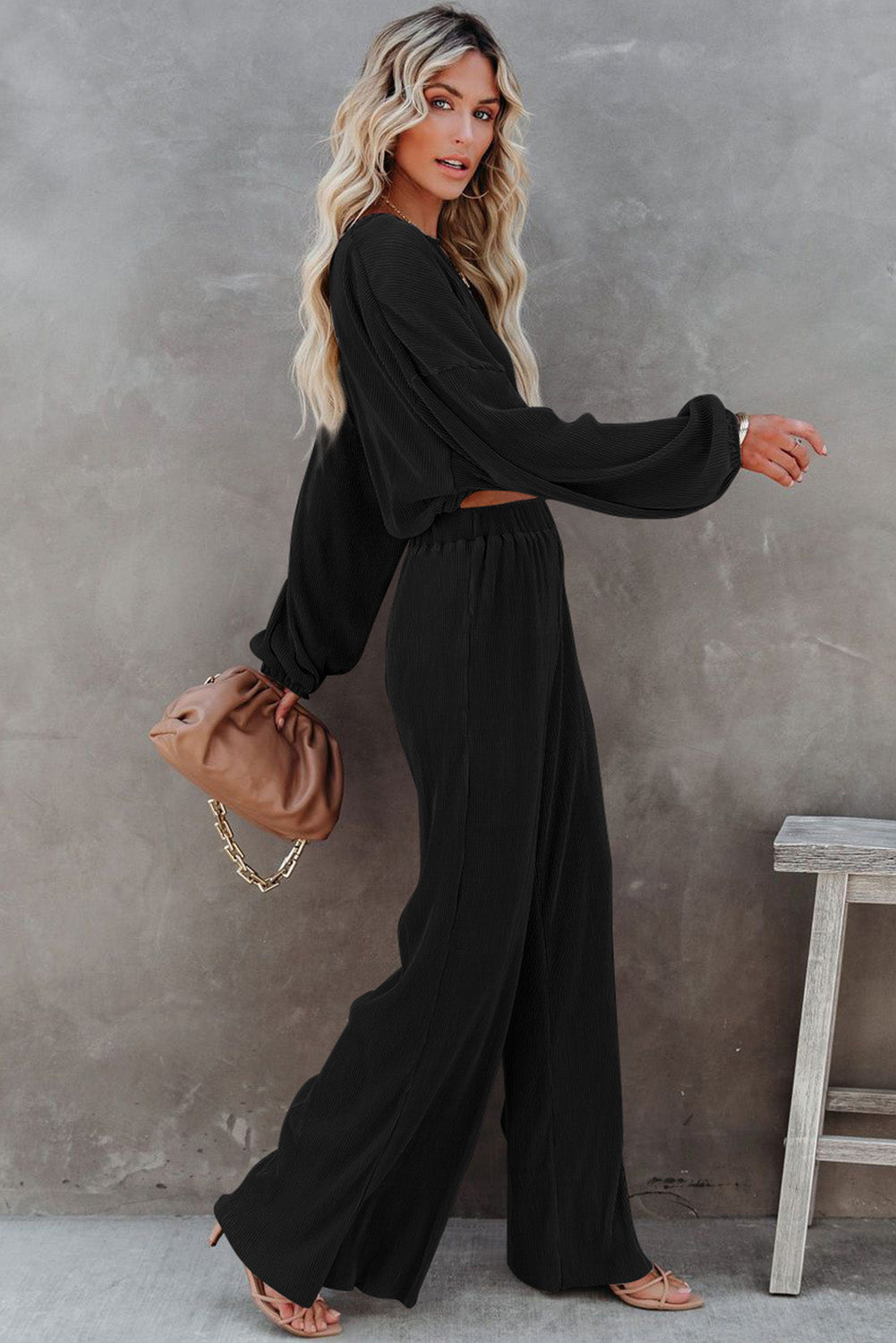 Elevate your fall wardrobe with our Black Cropped Pullover Sweater &amp; Wide Leg Pants Set. The cropped sweater adds a modern twist while the wide leg pants provide both comfort and style. Perfect for any occasion, this set will keep you looking effortlessly chic.