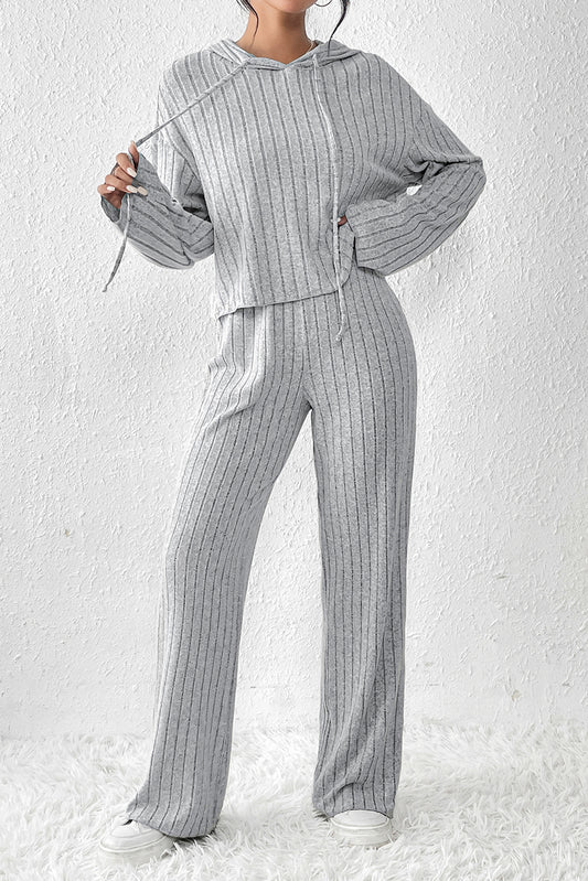 Indulge in ultimate comfort and style with our Gray Ribbed Knit Slouchy Hoodie Wide Leg Pants Set! This fashionable and versatile set features a drawstring hoodie and wide-leg pants, perfect for daily wear. The ribbed fabric adds visual interest without being overwhelming, while the soft and skin-friendly material provides unbeatable comfort. Elevate your wardrobe with this must-have set today!