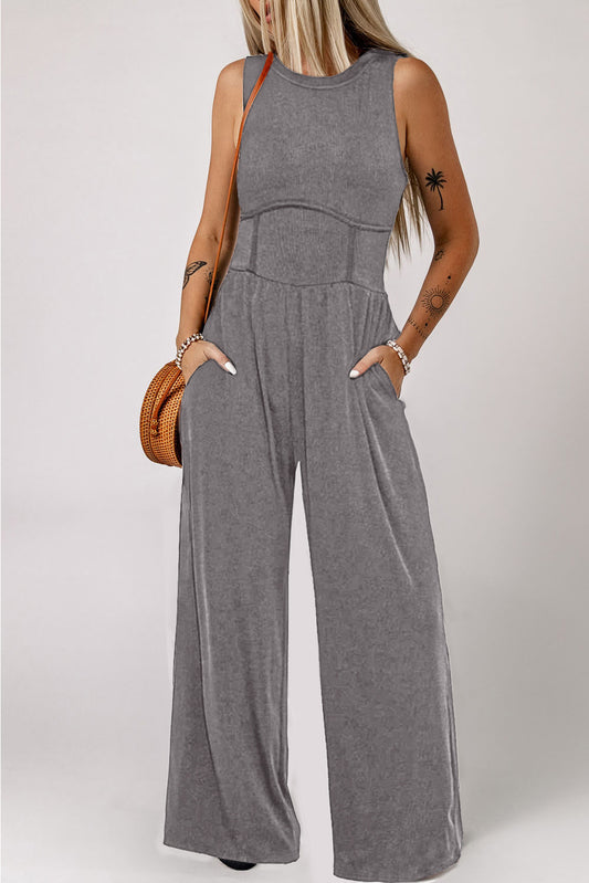 Elevate your style with our Medium Grey Cinched Waist Sleeveless Wide Leg Jumpsuit. Embrace comfort and fashion with the cinched waist and wide leg design. Perfect for a day out or a night on the town. Make a statement and turn heads with this must-have wardrobe staple.