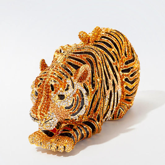 Roar your way to fashion success with our Crouching Tiger Rhinestone Clutch Bag! This playful accessory features a crouching tiger design adorned with dazzling rhinestones. It also comes with a convenient chain shoulder strap for easy carrying. Unleash your wild side with this quirky and glamorous bag!