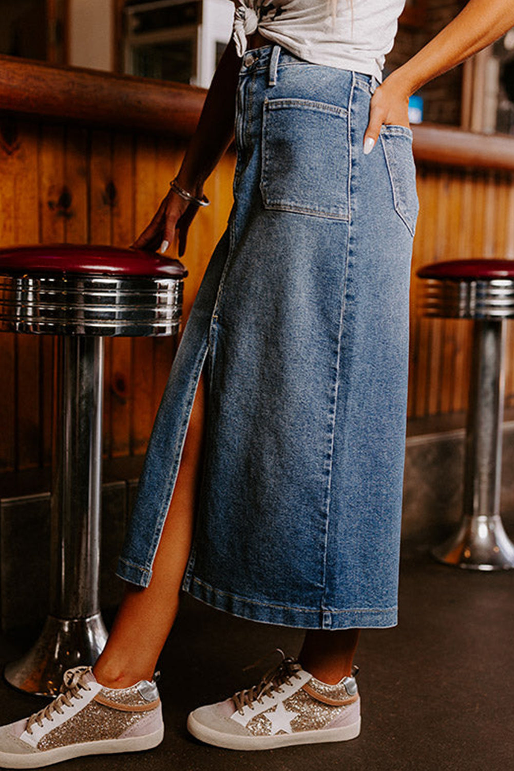 Elevate your wardrobe with our Classic Sky Blue Midi Denim Skirt! This stylish piece features a front slit and convenient pockets, adding a modern touch to the classic denim design. Perfect for any occasion, feel confident and fashionable in this must-have piece!