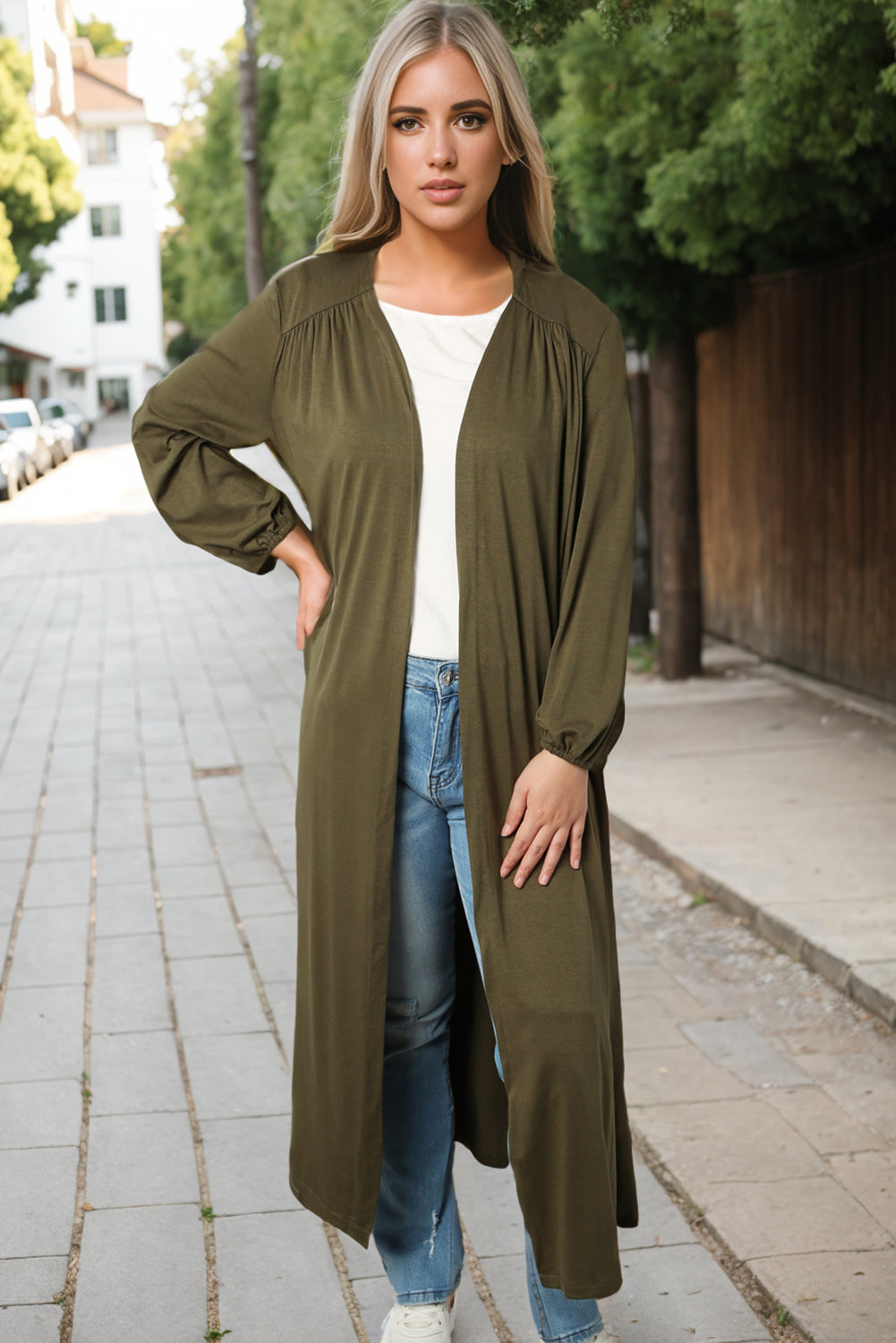 Slip into this cozy, free-flowing cardigan for ultimate comfort and movement. Its solid color design makes it a versatile choice for any outfit. The floor-sweeping length adds a touch of sophistication to your ensemble while keeping you warm. Don't forget the long sleeves for extra coziness and coverage!