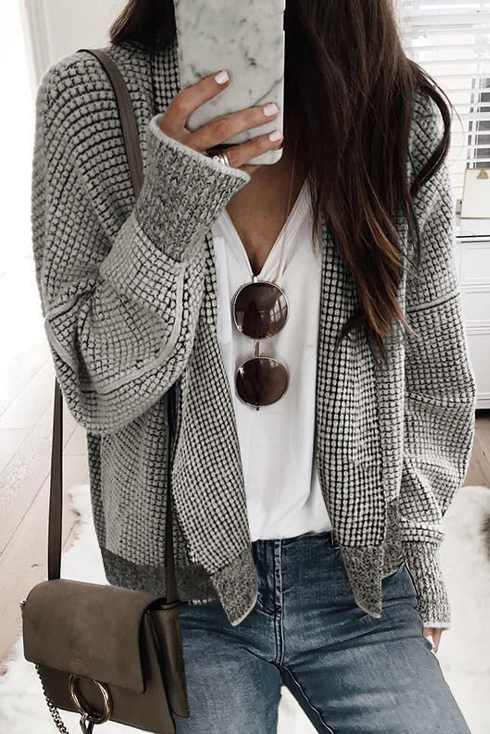 Add some shine to your outfit with our Grey Plaid Contrast Trim Open Front Cardigan. The classic plaid design, open front, and contrast trim make this cardigan perfect for any casual look. Made with soft fabric and a comfortable shift cut, this cardigan can be paired with a tank top, shorts, pants, or leggings for a stylish and cozy ensemble.