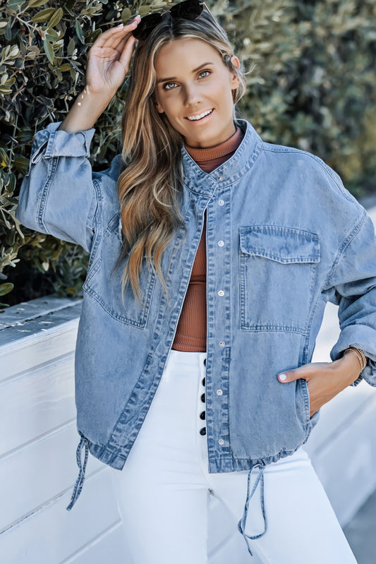 Feeling casual and cool? Look no further! Our Sky Blue Roll-Up Tab Sleeve Button Down Pocket Denim Jacket, made with high-quality denim, will surely keep you comfortable and stylish. With a drawstring hem and rolled up sleeves, create the perfect fit for any occasion.