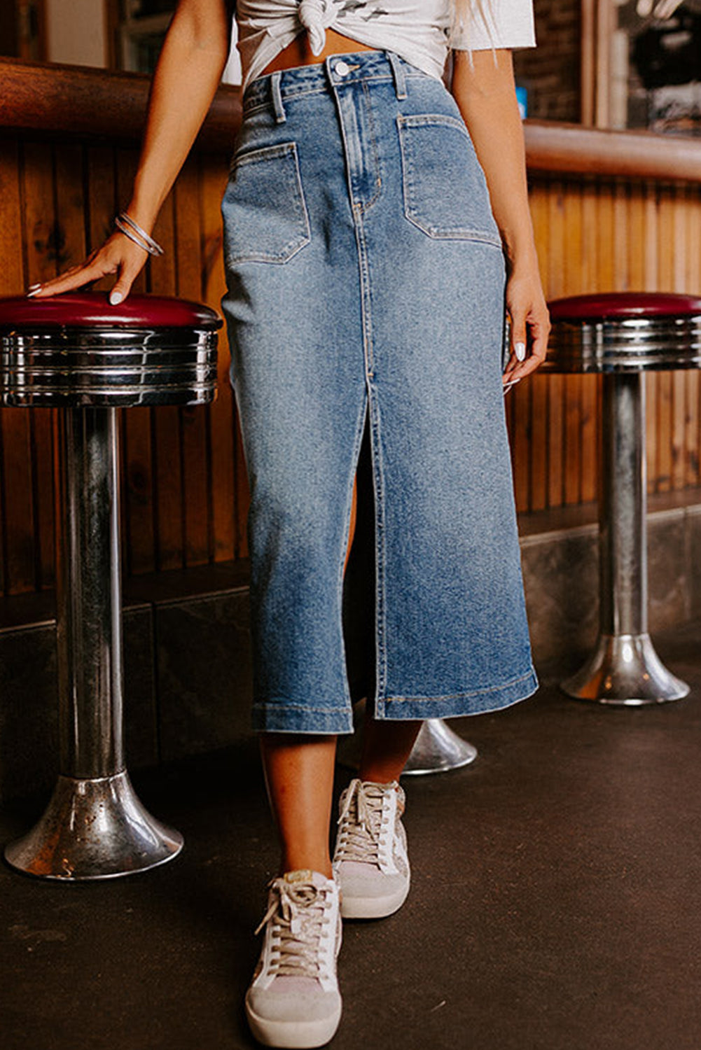 Elevate your wardrobe with our Classic Sky Blue Midi Denim Skirt! This stylish piece features a front slit and convenient pockets, adding a modern touch to the classic denim design. Perfect for any occasion, feel confident and fashionable in this must-have piece!