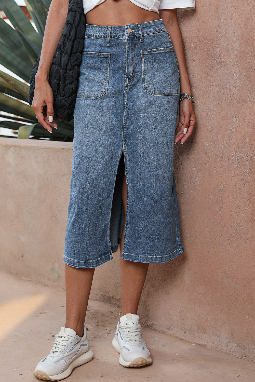 Elevate your wardrobe with our Classic Sky Blue Midi Denim Skirt! This stylish piece features a front slit and convenient pockets, adding a modern touch to the classic denim design. Perfect for any occasion, feel confident and fashionable in this must-have piece!