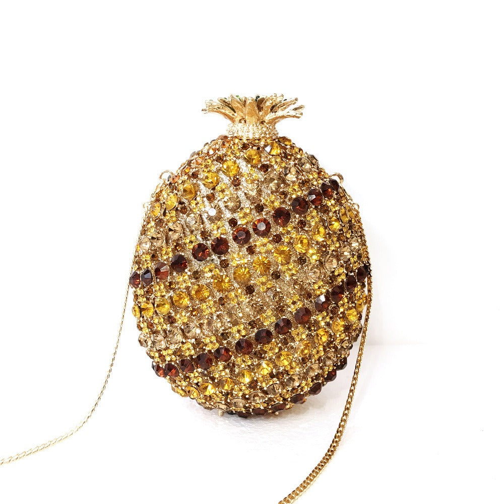 Indulge in the luxurious elegance of our Fruit pineapple shaped crystal banquet bag! Featuring a stunning diamond inlay and rhinestone details, this clutch bag exudes sophistication and glamour. With a convenient chain shoulder strap, it comes in both red and gold for the perfect touch of color. Elevate any outfit with this must-have accessory.