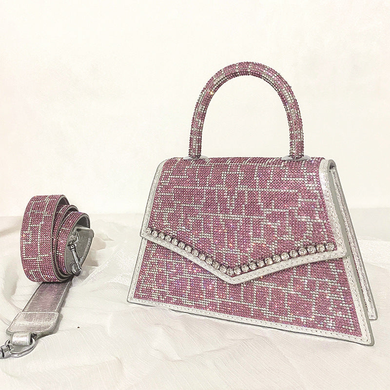 Add sparkle to your style with our Rhinestone Square Stand Alone Top Handle Bag! The rhinestone accents on the bag, purse, and shoulder strap elevate any outfit and make a statement. Stand out from the crowd with this luxurious and eye-catching accessory.