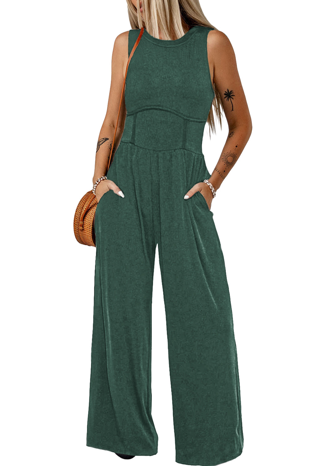 Made from high-quality fabric, this jumpsuit exudes luxury with its deep green hue, adding a touch of richness and depth to your ensemble. The sleeveless design and wide-leg silhouette create a flattering and elongating effect, while offering freedom of movement and comfort.