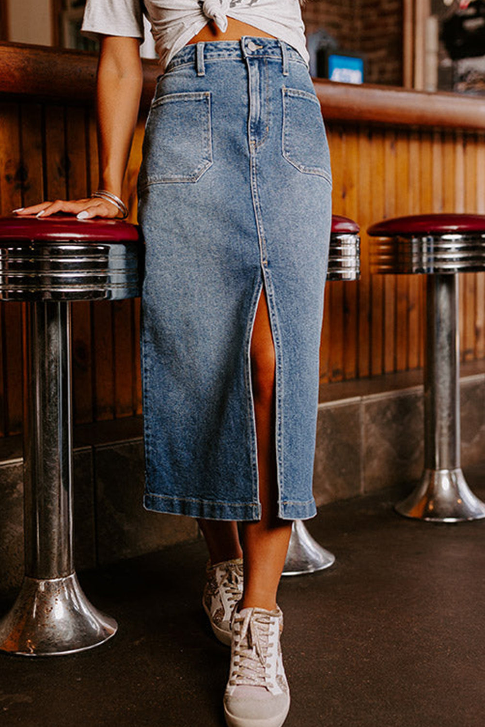 Elevate your wardrobe with our Classic Sky Blue Midi Denim Skirt! This stylish piece features a front slit and convenient pockets, adding a modern touch to the classic denim design. Perfect for any occasion, feel confident and fashionable in this must-have piece!