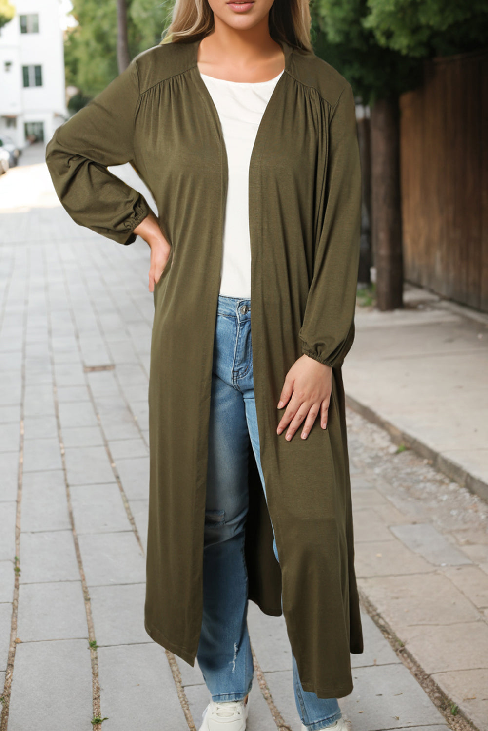 Slip into this cozy, free-flowing cardigan for ultimate comfort and movement. Its solid color design makes it a versatile choice for any outfit. The floor-sweeping length adds a touch of sophistication to your ensemble while keeping you warm. Don't forget the long sleeves for extra coziness and coverage!