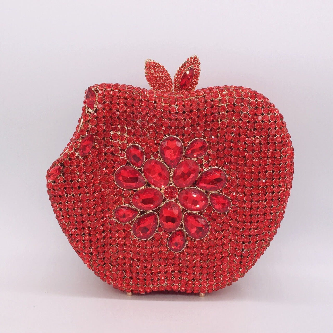 Add a pop of whimsy and style to your outfit with our Rhinestone Apple Shaped Handbag! Available in 8 vibrant colors, this playful clutch features a detailed rhinestone apple design and a convenient chain shoulder strap. Perfect for any fashionista looking to make a statement! (No worms included.)