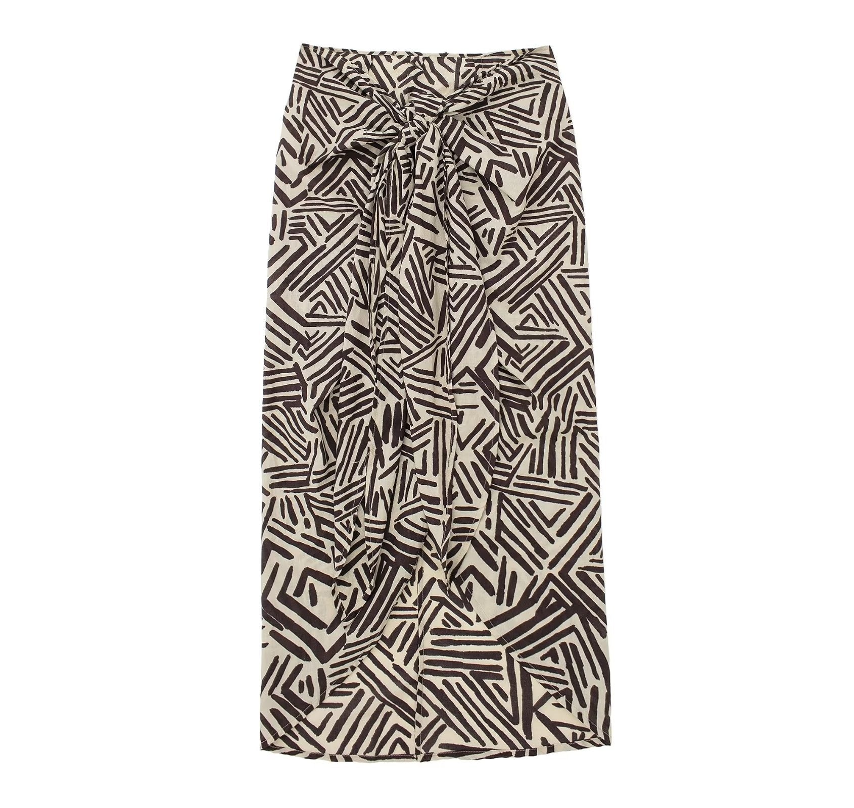 Add a touch of elegance to your summer wardrobe with our one-size-fits-all flowy skirt! Featuring a bold graphic print in red, or a chic tan and black option, this skirt is perfect for any occasion - whether it be a day at the office, a fun evening out, or a casual daytime look. Stay stylish and comfortable all summer long!