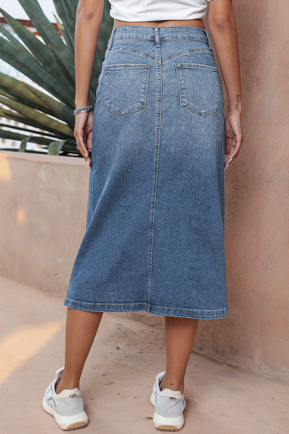 Elevate your wardrobe with our Classic Sky Blue Midi Denim Skirt! This stylish piece features a front slit and convenient pockets, adding a modern touch to the classic denim design. Perfect for any occasion, feel confident and fashionable in this must-have piece!