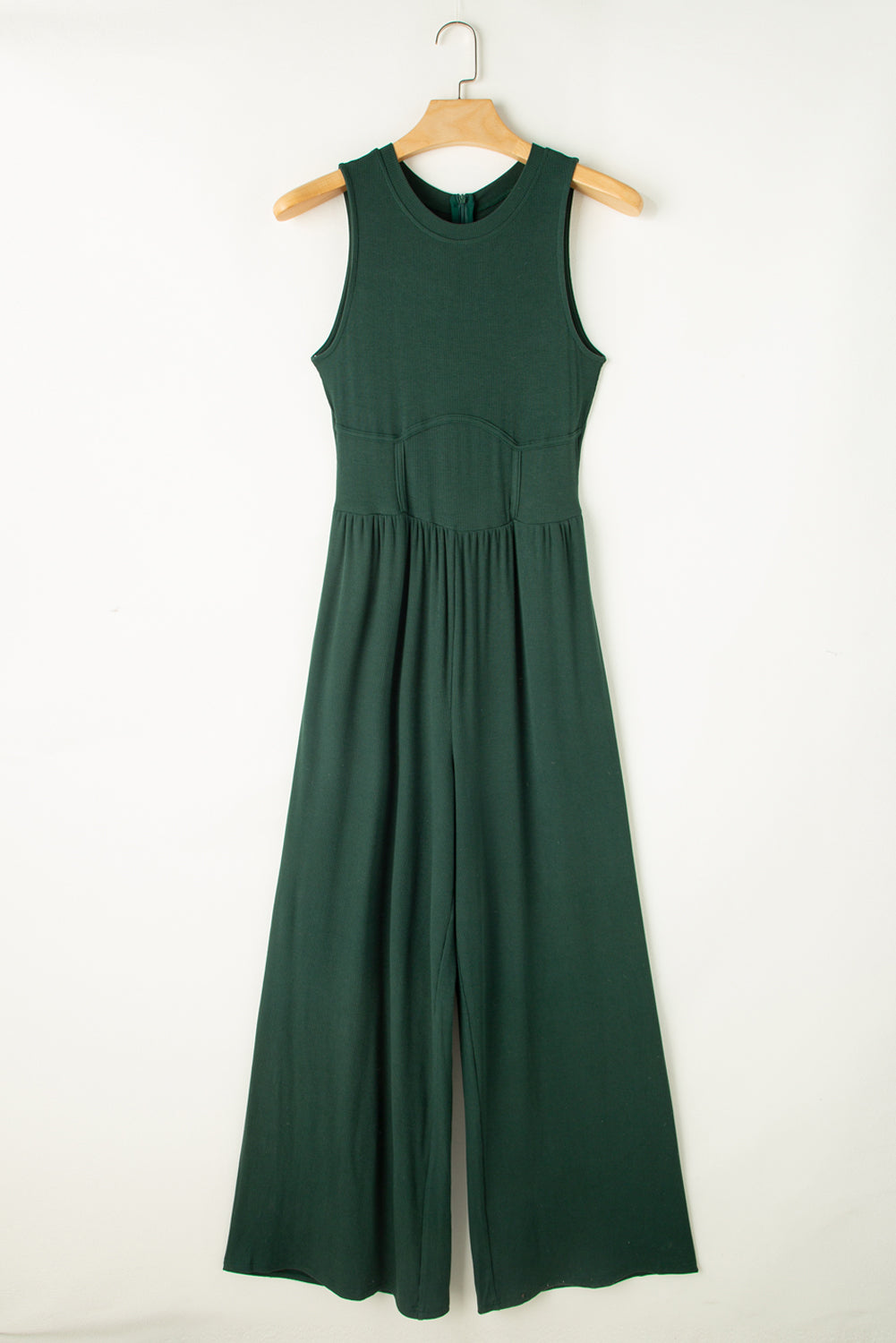 Made from high-quality fabric, this jumpsuit exudes luxury with its deep green hue, adding a touch of richness and depth to your ensemble. The sleeveless design and wide-leg silhouette create a flattering and elongating effect, while offering freedom of movement and comfort.