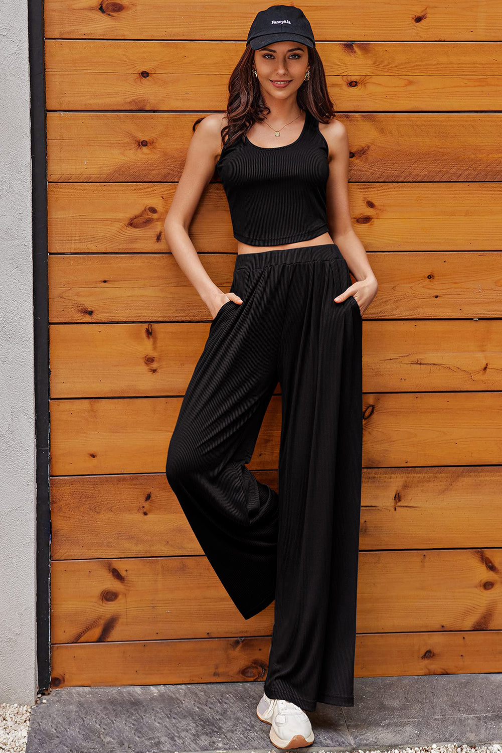 Unleash your inner fashionista with this Black Textured Sleeveless Crop Top and Wide Leg Pants Outfit. The trendy crop top and loose wide leg pants can be mixed and matched for endless styling options. Perfect for any occasion, this versatile set will flatter your curves and elongate your legs. Dress to impress with ease!