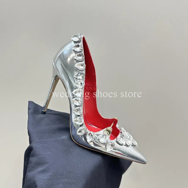 These stunning Rhinestone Studded High Heels are the perfect addition to any wardrobe. Made from high-quality patent leather with a sexy pointed toe design, these stiletto heels are both fashionable and functional. The rhinestone details add a touch of glamour, making you feel confident and luxurious with every step. Elevate your style game with these must-have heels!