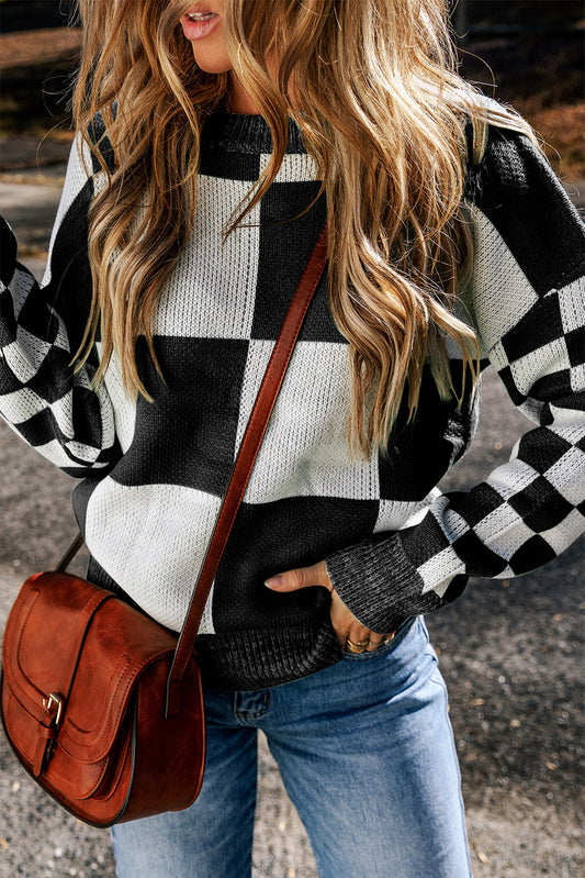 Pump up your wardrobe with our Black and White Checkered Print Drop Shoulder Sweater! Featuring a playful color block design, and trendy checkered sleeves, this oversized sweater is the perfect blend of style and comfort. Go bold and stand out in this must-have women's sweater!