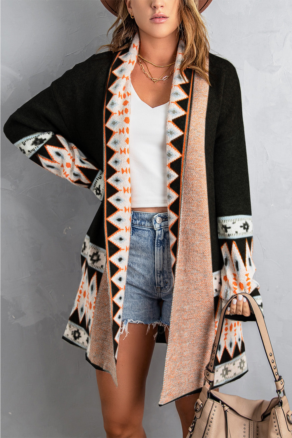 Stay cozy and stylish with our Black Aztec Print Open Front Knitted Cardigan. This cardigan features a trendy lapel collar and a unique black and Aztec print design. Perfect for layering or adding a pop of pattern to your outfit. (Kick your style up a notch with this on-trend cardigan!)