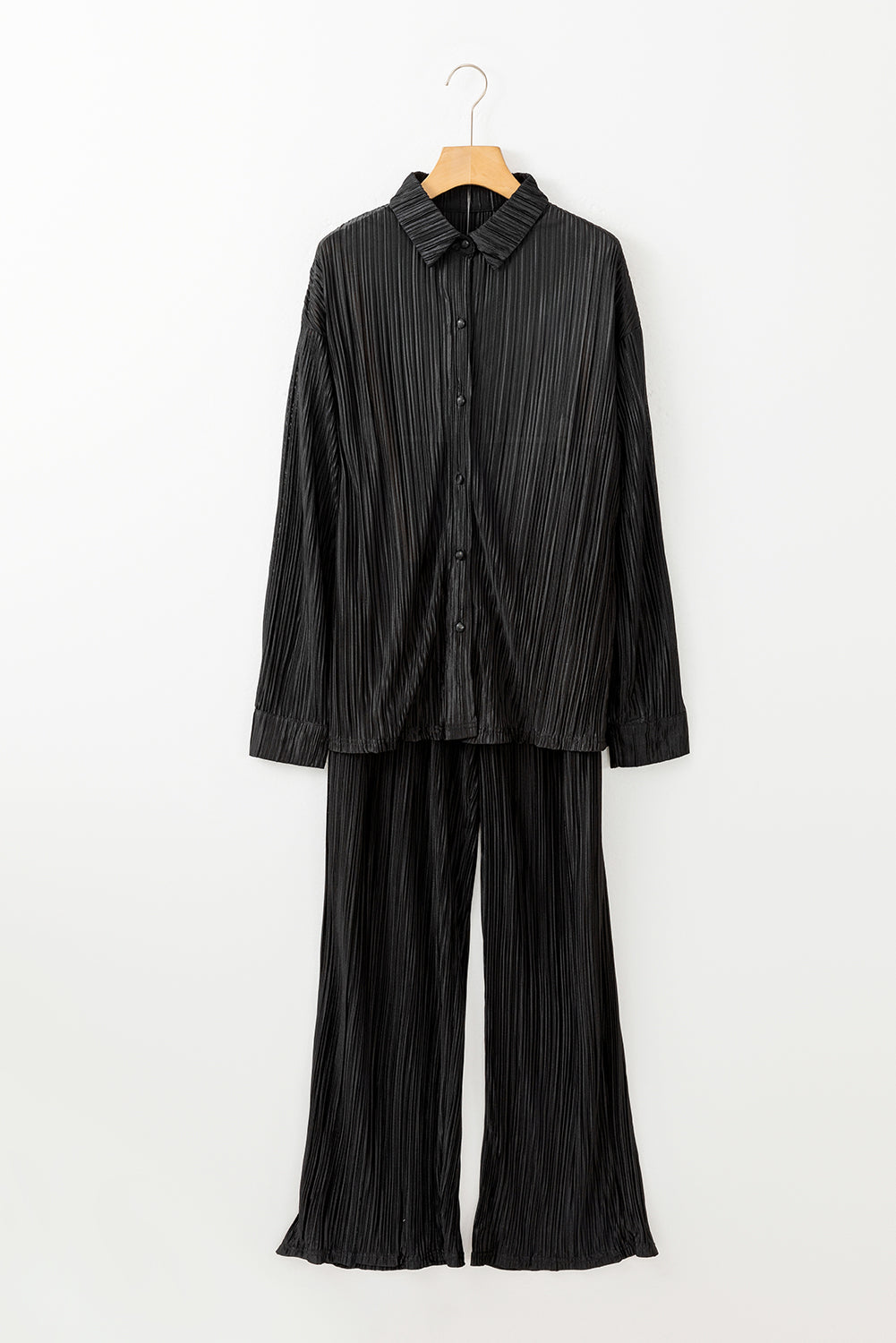 Effortlessly stylish and versatile, this black pleated set includes a long sleeve shirt and wide-leg pants to elevate your wardrobe. Perfect for any occasion, the soft and breathable fabric ensures comfort while the chic design exudes confidence. Embrace sophistication and make a statement with this must-have set!