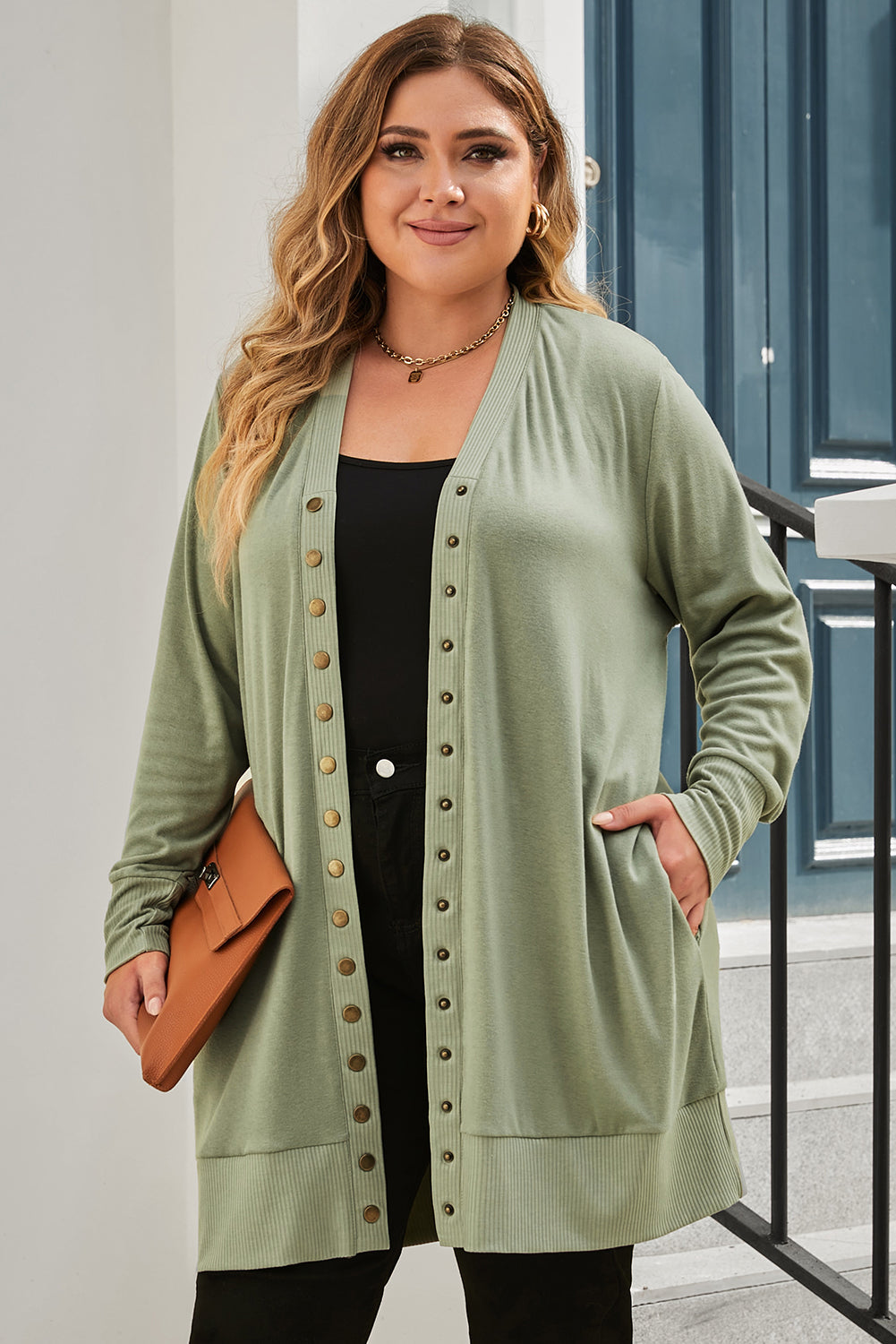 A versatile and dainty addition to any wardrobe, this green plus-size cardigan features a snap-button closure and ribbed trim for a vintage feel. With convenient pockets, it's perfect for adding a touch of warmth while running errands or lounging at home. Pair with a long-sleeve top and skinny pants for a complete casual look. (Fits ladies of all sizes!)