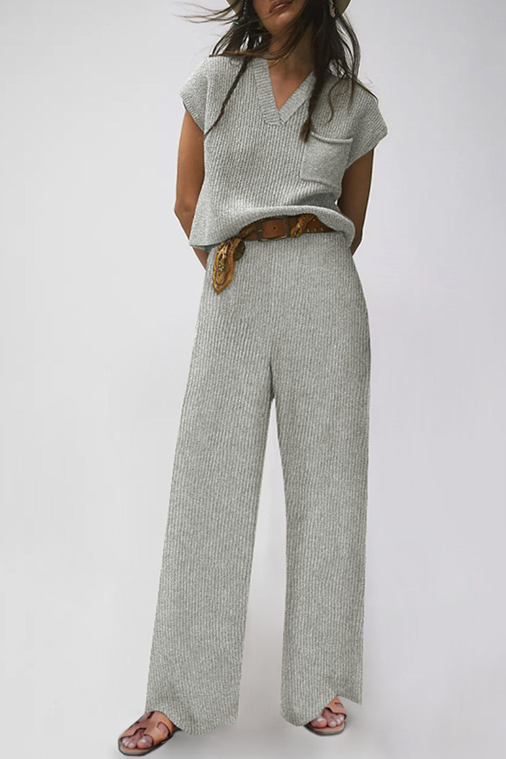 Stay stylish and cozy this fall and winter with our Gray Knitted V Neck Sweater and Casual Pants Set! Made with soft and warm knitted material, this set will keep you comfortable while looking effortlessly chic. The cap sleeve sweater is great for layering or wearing on its own, while the wide pants offer both comfort and style. Upgrade your wardrobe with this must-have set!