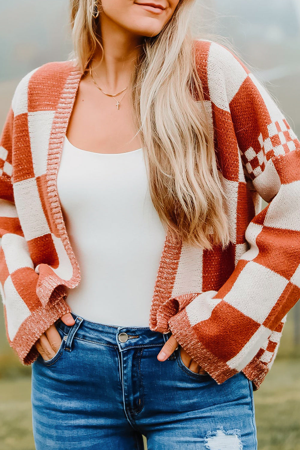 Introducing our Chestnut Mix Checkered Cardigan, a chic and classic addition to any wardrobe. Its checkered pattern is sure to make you fall in love with this knit coat. The open front design makes it easy to layer over any outfit, perfect for pairing with jeans, skirts, or dresses.