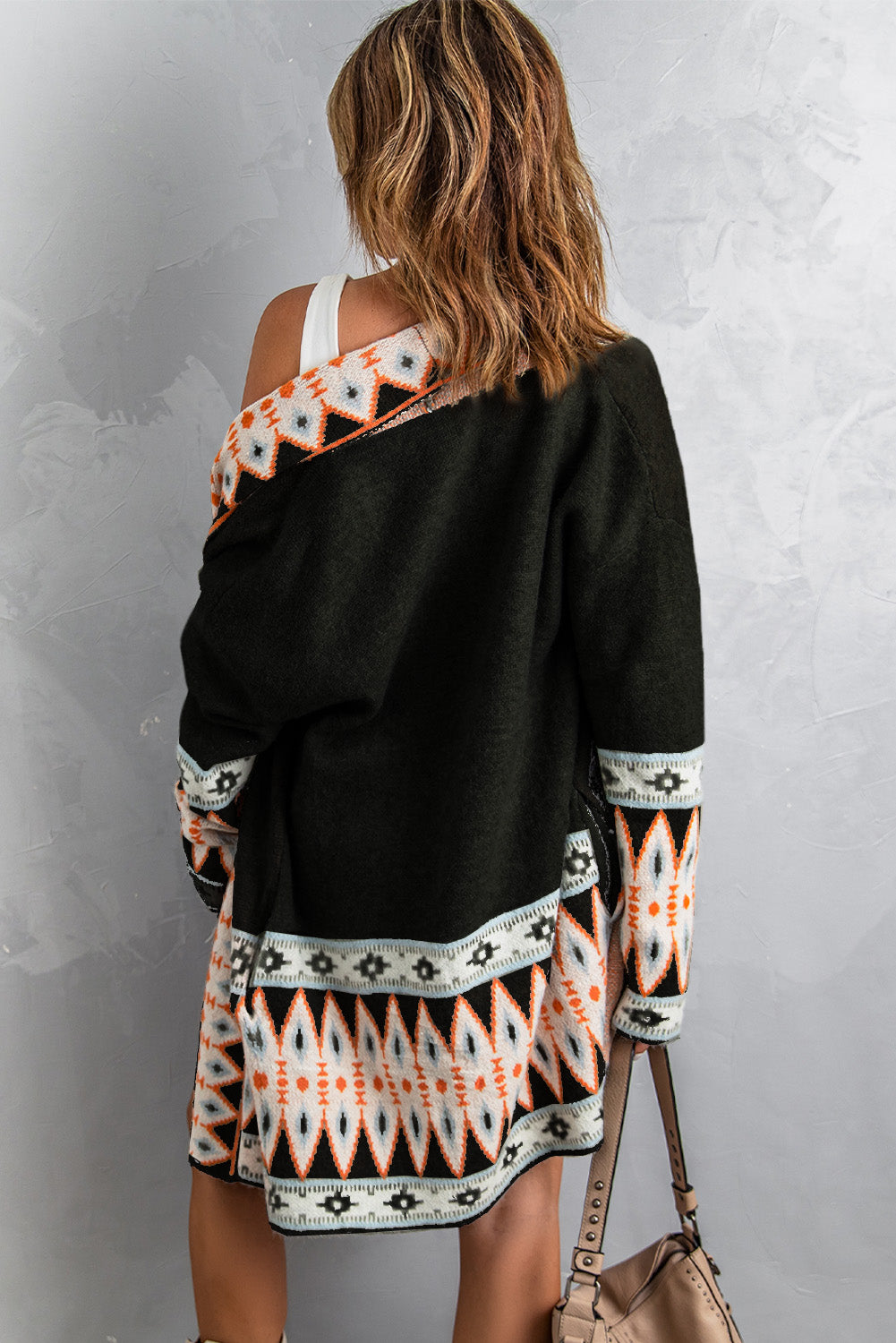 Stay cozy and stylish with our Black Aztec Print Open Front Knitted Cardigan. This cardigan features a trendy lapel collar and a unique black and Aztec print design. Perfect for layering or adding a pop of pattern to your outfit. (Kick your style up a notch with this on-trend cardigan!)