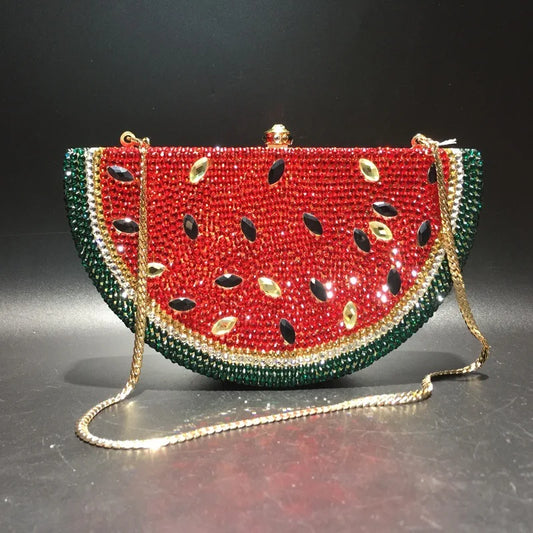 Experience a touch of elegance with our Rhinestone Watermelon Clutch Purse! This stunning bag features intricate rhinestone detailing in a fun watermelon design. The gold shoulder strap adds a touch of luxury, making it perfect for special occasions and adding a pop of personality to any outfit. Make a statement with this standout accessory!