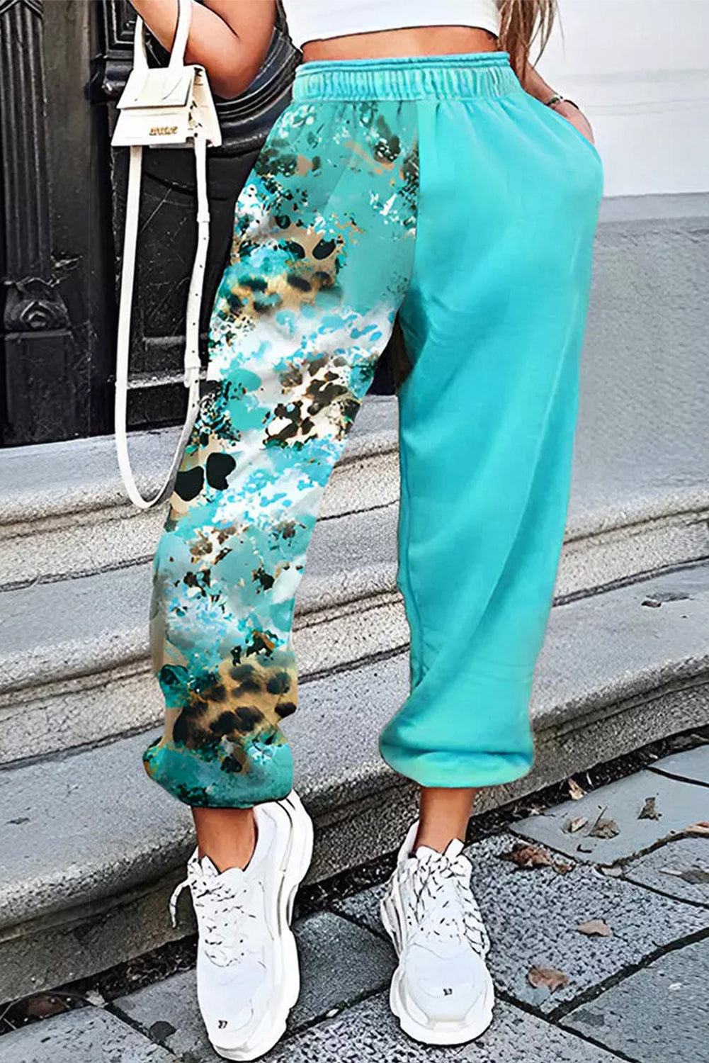 Unleash your inner fashionista with our Stylish Casual Turquoise Contrast Leopard Tie-Dye Print Sweatpants. Featuring a unique combination of turquoise, leopard, and tie-dye prints, these sweatpants will elevate your casual look. Made with high-quality materials, they offer both style and comfort. Make a statement and stand out from the crowd with these must-have sweatpants!