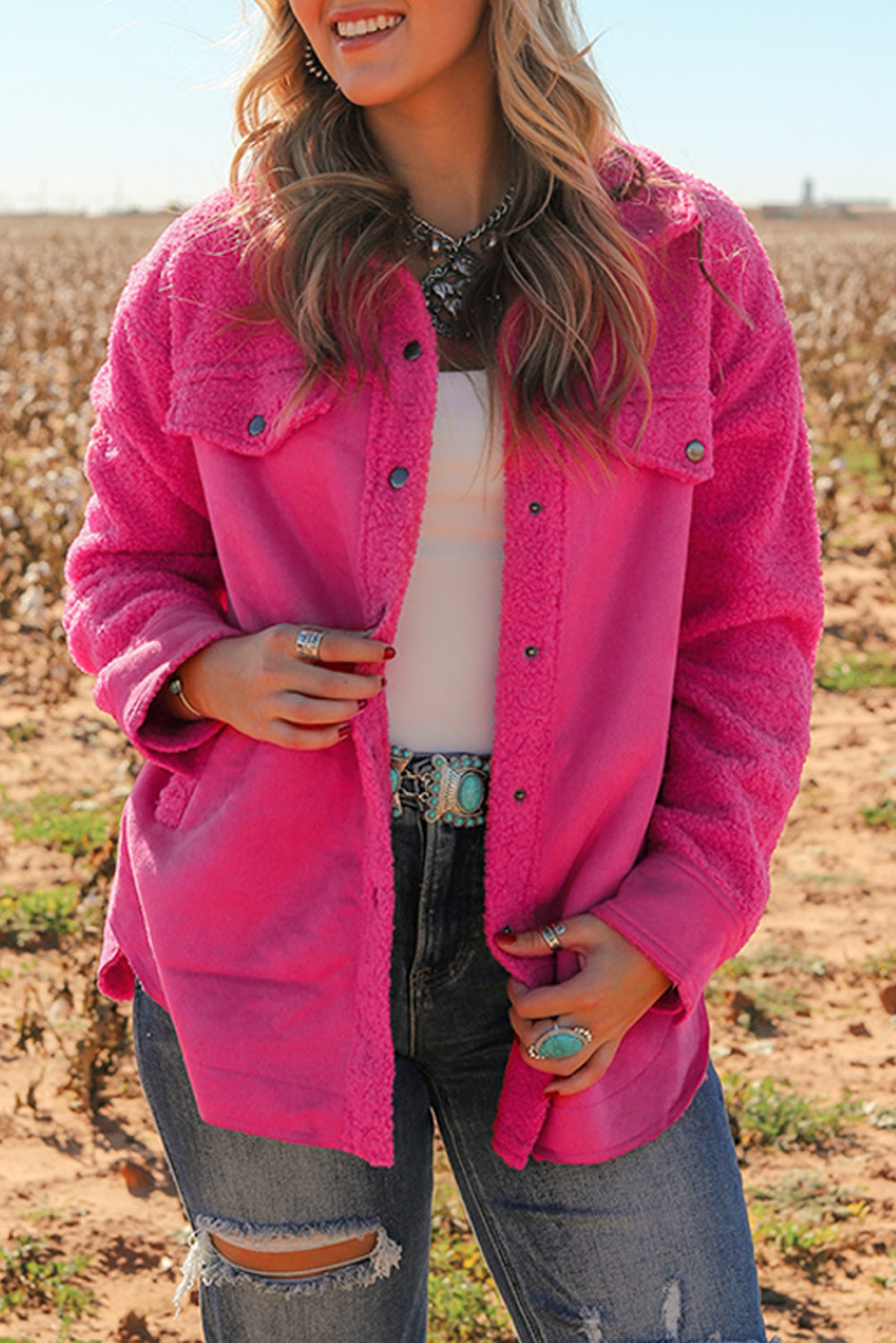 Introducing a cozy yet vibrant addition to your wardrobe: the Bright Pink Faux Suede Sherpa Button-Up Cardigan. Crafted with comfort and style in mind, this cardigan offers both warmth and flair, perfect for the modern woman who values both fashion and functionality