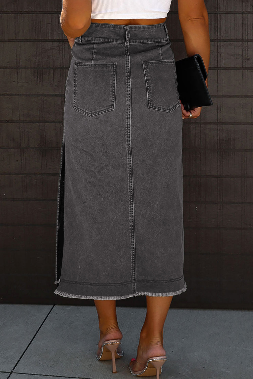 Introducing our stunning Black Raw Edge Side Slits Button Up Midi Denim Skirt! Crafted with high-quality denim, this skirt is perfect for any occasion. The raw edge and side slits add a touch of edginess, while the button-up design adds a dash of sophistication. Elevate your wardrobe with this must-have piece!