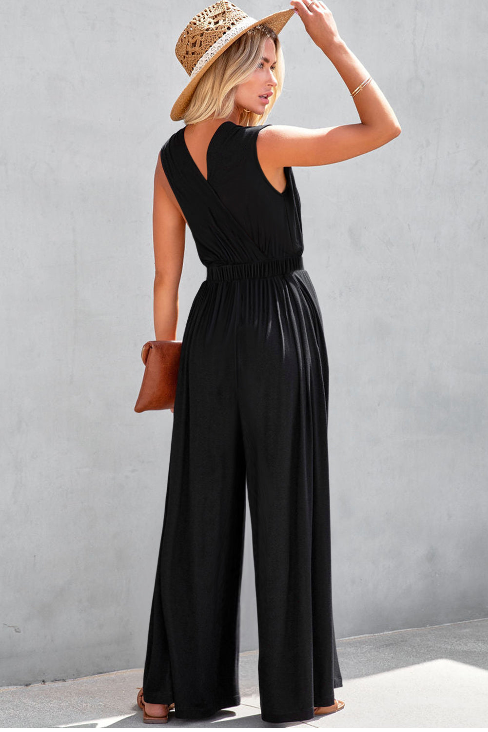 Get ready to turn heads with our Black Deep V Neck Pleated Crisscross Wide Leg Casual Backless Jumpsuit! This chic and versatile piece features a trendy deep v neck and a unique crisscross design, while the pleated details and wide leg cut give it a flattering and stylish look. Perfect for any occasion, from a casual day out to a night out on the town!