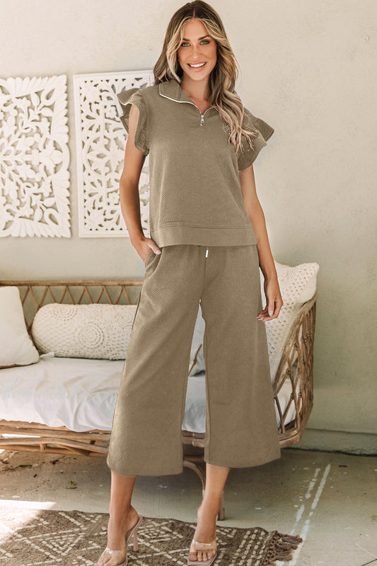 Effortlessly chic, our Pale Khaki Textured Flutter Sleeve Top and Wide Leg Pants Set will elevate your wardrobe. The textured fabric adds subtle interest while the flutter sleeves and wide leg pants provide comfort and style. Perfect for any occasion, this set is a must-have for any fashion-forward woman!