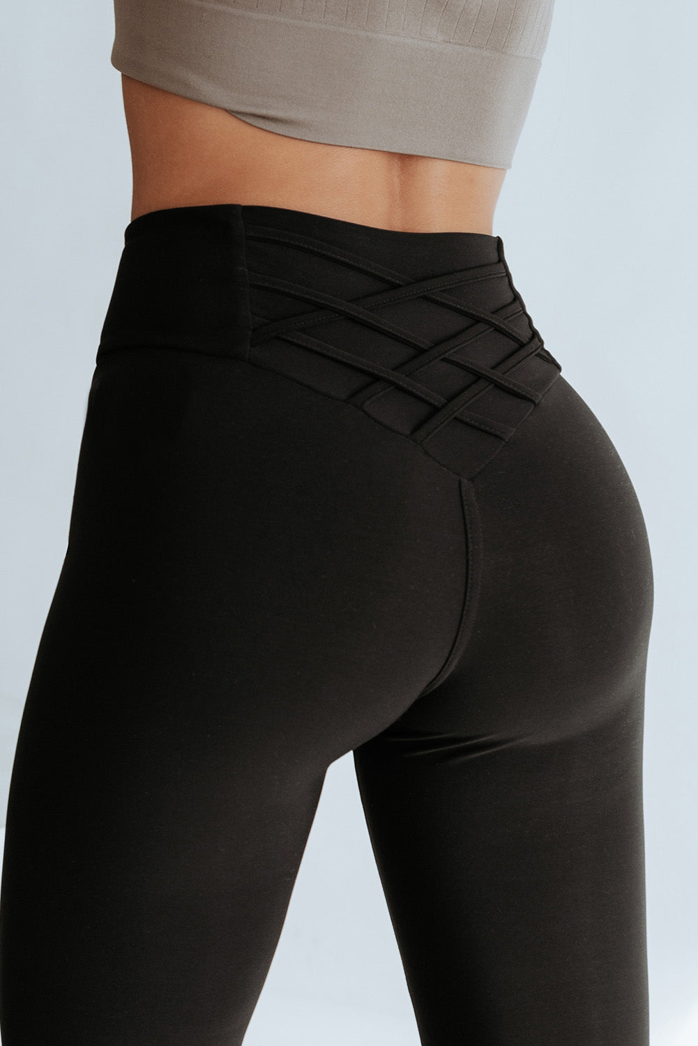 Flaunt your figure with our Black Criss Cross Tummy Control High Waist Leggings! Designed to give you a sleek and smooth silhouette, these leggings feature a high waist and criss cross detailing to enhance your curves and provide ultimate tummy control. Feel confident and comfortable all day long!