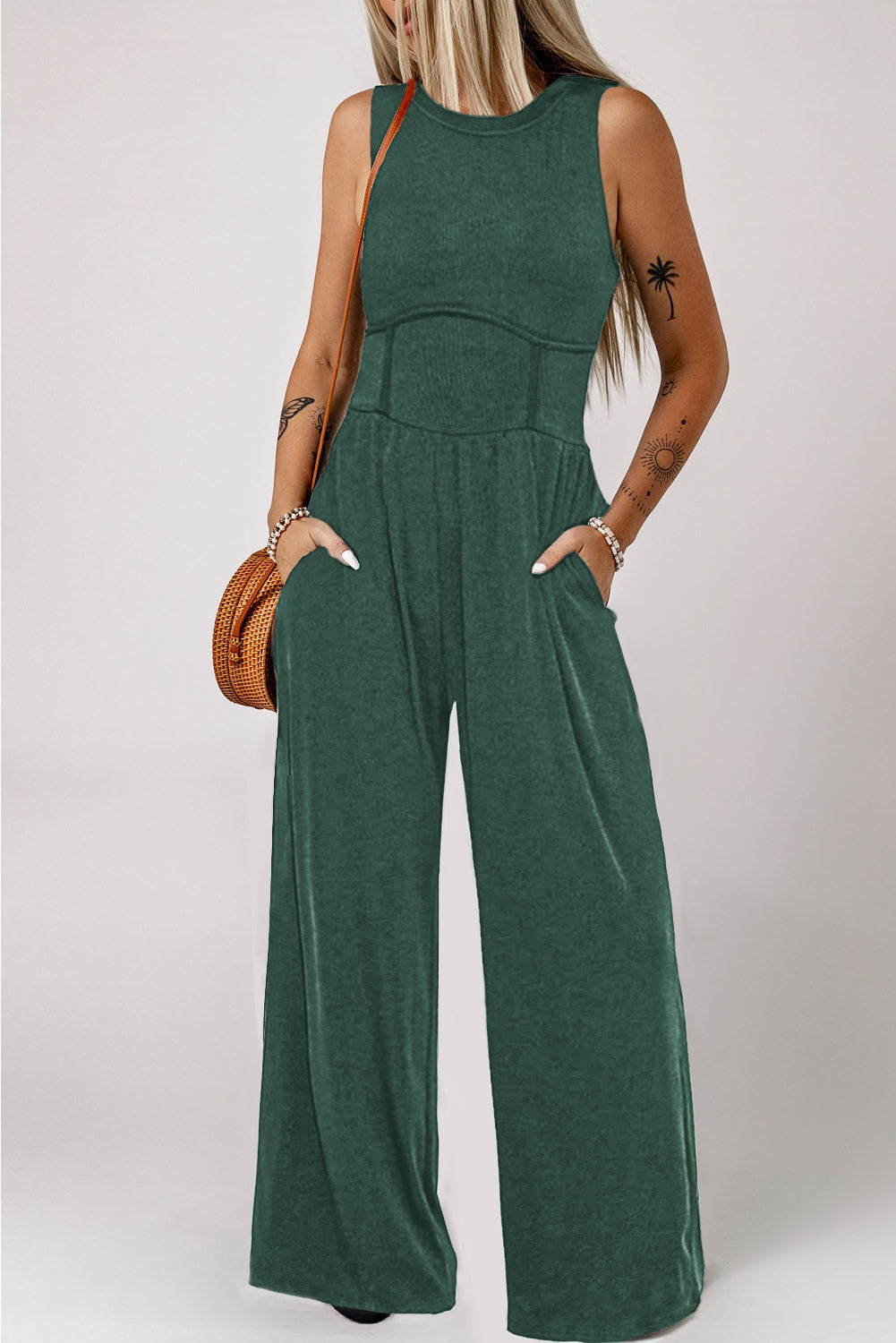 Made from high-quality fabric, this jumpsuit exudes luxury with its deep green hue, adding a touch of richness and depth to your ensemble. The sleeveless design and wide-leg silhouette create a flattering and elongating effect, while offering freedom of movement and comfort.