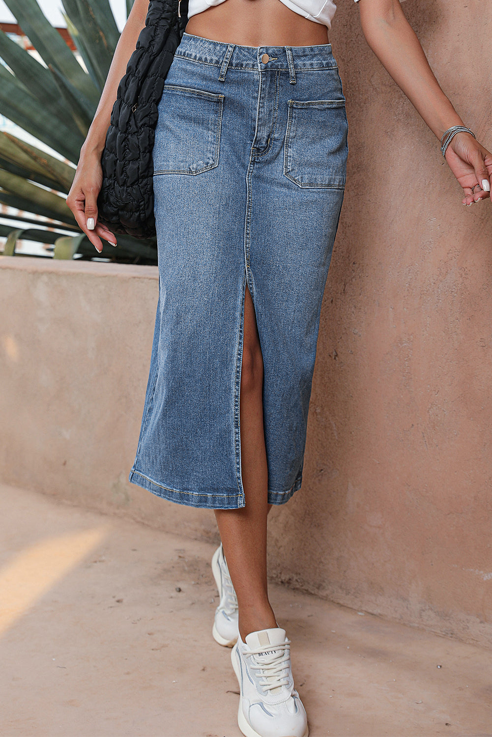 Elevate your wardrobe with our Classic Sky Blue Midi Denim Skirt! This stylish piece features a front slit and convenient pockets, adding a modern touch to the classic denim design. Perfect for any occasion, feel confident and fashionable in this must-have piece!