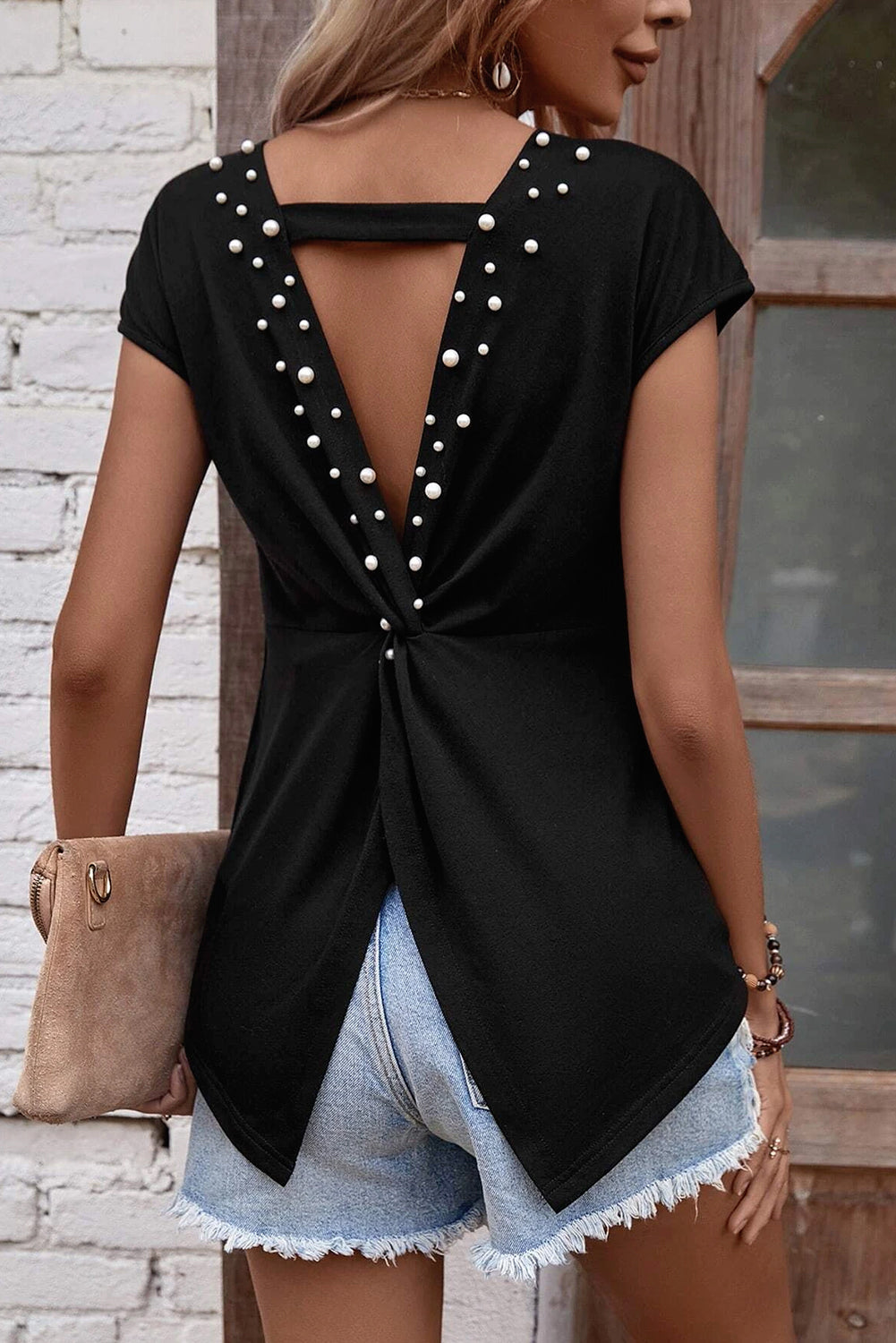 Looking for something that will add a touch of elegance to your casual wardrobe? Look no further than our Black Pearls Embellished Twist Back Tee! With a unique twist back design and glimmering black pearl embellishments, this tee is perfect for a playful and chic look.