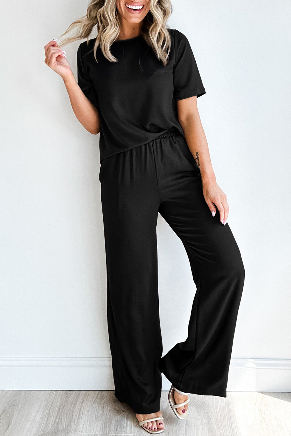 Elevate your wardrobe with our Black Two-Piece Solid Color T Shirt and Wide Leg Pants Set! This stylish set features a flattering black color and comfortable design. Perfect for any occasion, this set will make you look and feel your best. Upgrade your fashion game now!