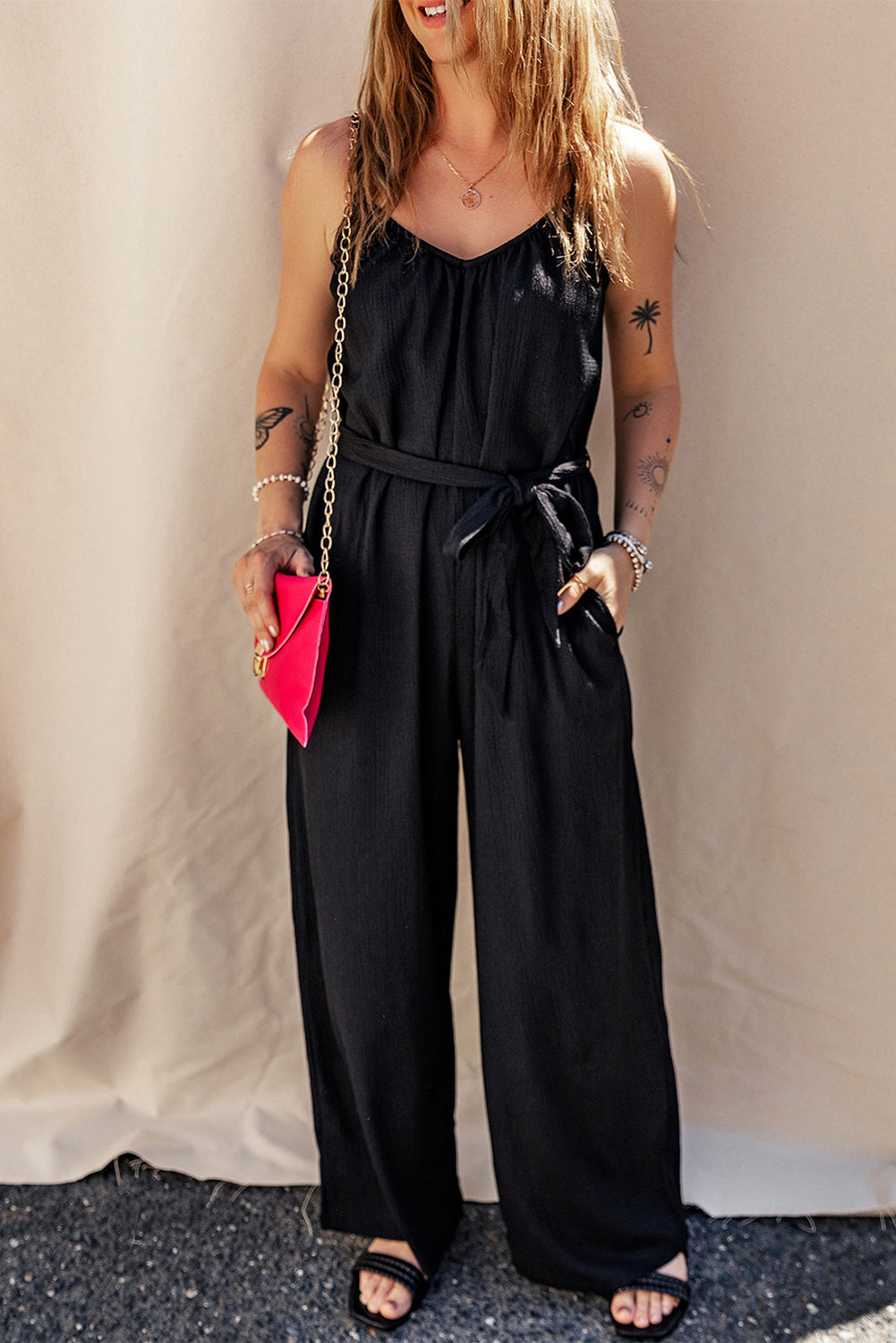 Elevate your style with our Black Textured Belted Wide Leg Sleeveless Jumpsuit. This elegant piece is designed to offer comfort and versatility, with its wide leg design and sleeveless top. The textured fabric and belted waist add a touch of sophistication, making it perfect for any occasion. Step out in style and turn heads wherever you go!