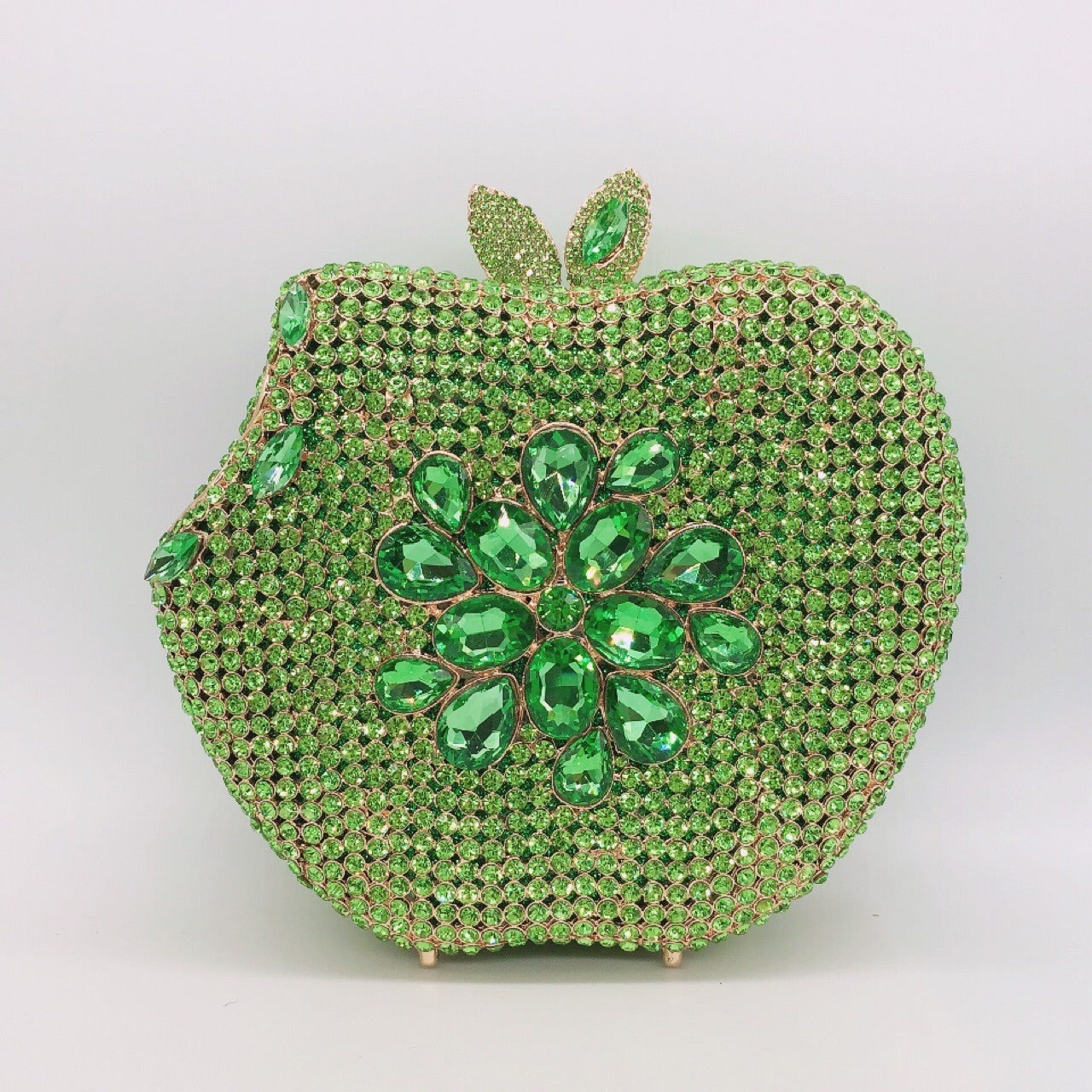 Add a pop of whimsy and style to your outfit with our Rhinestone Apple Shaped Handbag! Available in 8 vibrant colors, this playful clutch features a detailed rhinestone apple design and a convenient chain shoulder strap. Perfect for any fashionista looking to make a statement! (No worms included.)