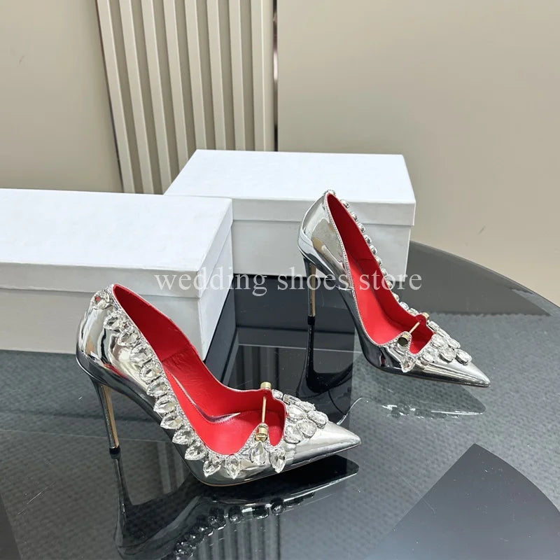 These stunning Rhinestone Studded High Heels are the perfect addition to any wardrobe. Made from high-quality patent leather with a sexy pointed toe design, these stiletto heels are both fashionable and functional. The rhinestone details add a touch of glamour, making you feel confident and luxurious with every step. Elevate your style game with these must-have heels!