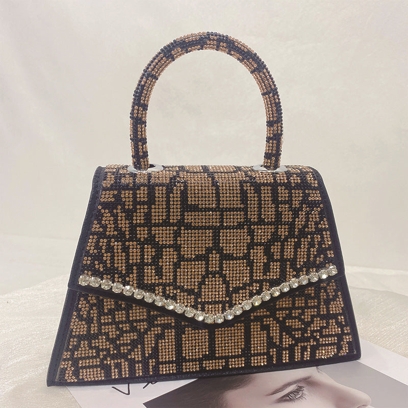 Add sparkle to your style with our Rhinestone Square Stand Alone Top Handle Bag! The rhinestone accents on the bag, purse, and shoulder strap elevate any outfit and make a statement. Stand out from the crowd with this luxurious and eye-catching accessory.