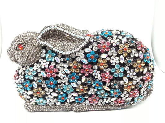 Elevate your style with our Rhinestone Bunny Clutch! This eye-catching accessory features a playful bunny design adorned with sparkling rhinestones. Perfect for adding a touch of whimsy to any outfit, while keeping your essentials secure. Make a statement and indulge in luxury with our Rhinestone Bunny Clutch.