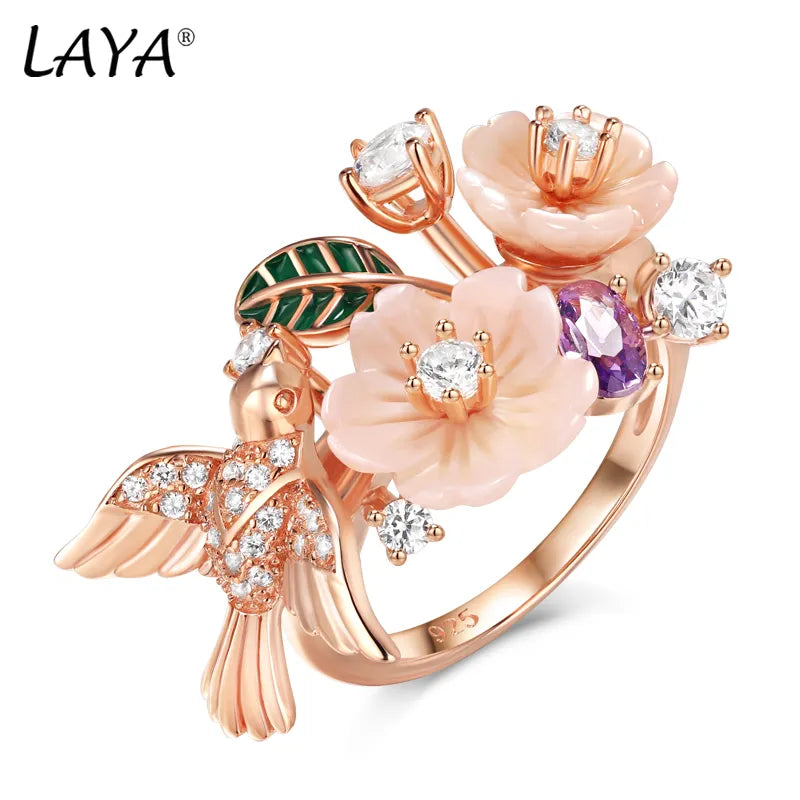 Flaunt your fun, whimsical side with this Zircon and Natural Shell Bird and Flowers Women's Ring. Available in Sterling Silver or Rose Gold, the ring features a unique bird and flower design crafted with sparkling zircon and natural shell. A playful addition to any outfit!